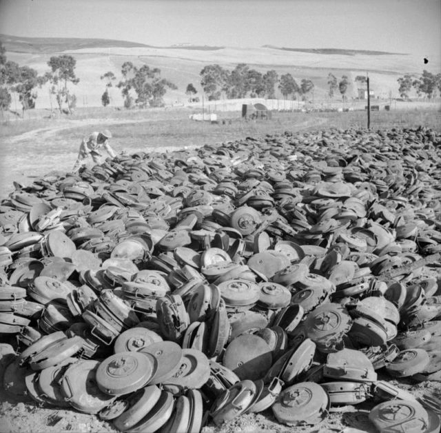A huge dump of German Teller mines captured by the Americans near Roccopalunba during their drive on Palermo. [© IWM (NA 5130)]