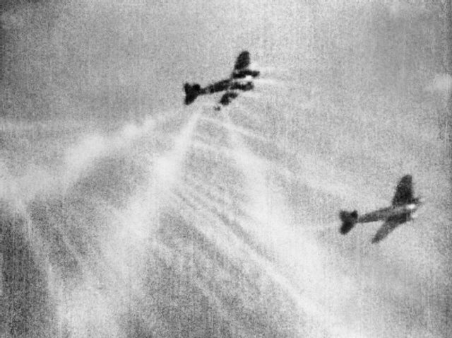 A still from camera gun film shows tracer ammunition from a Supermarine Spitfire Mark I of No. 609 Squadron RAF, flown by Flight Lieutenant J H G McArthur, hitting a Heinkel He 111 on its starboard quarter. These aircraft were part of a large formation from KG 53 and KG 55 which attacked the Bristol Aeroplane Company's works at Filton, Bristol, just before midday on 25 September 1940. [© IWM (CH 1823)]