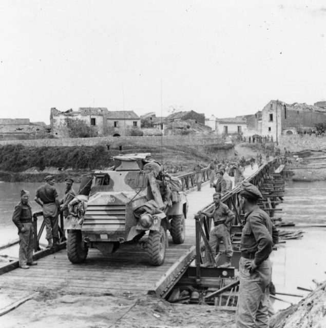 An Otter light reconnaissance car crossing a Bailey bridge over the Volturno river at Grazzanise, Italy.