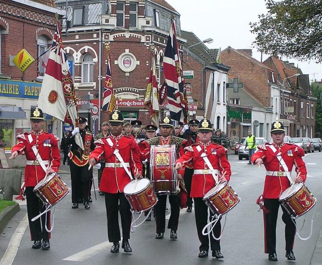 The drums platoon of the Duke of Wellington's Regiment (West Riding), leading the regiment, with its colours, through Erquinghem-Lys, France to the Town Hall to receive the keys to the town in 2005. Richard Harvey / Wikimedia Commons / CC BY 2.5