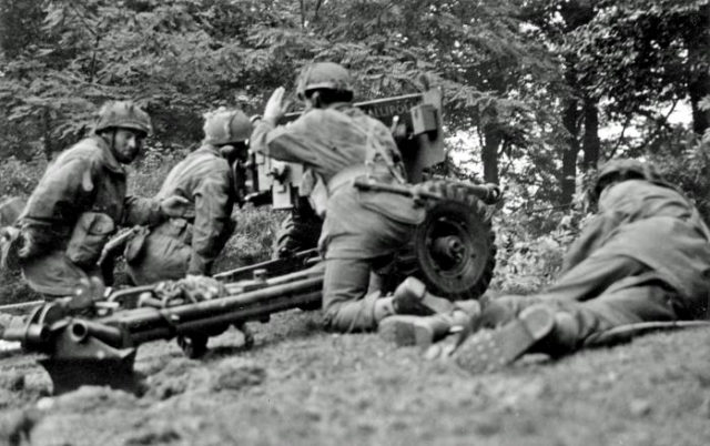 A 6 pounder anti–tank gun of the Border Regiment engages enemy armour on the western perimeter of Oosterbeek, on the same day as Baskeyfield's action. By Smith (Sgt), No 5 Army Film & Photographic Unit. - Imperial War Museum, Image number BU1109, Public Domain, https://commons.wikimedia.org/w/index.php?curid=16476471