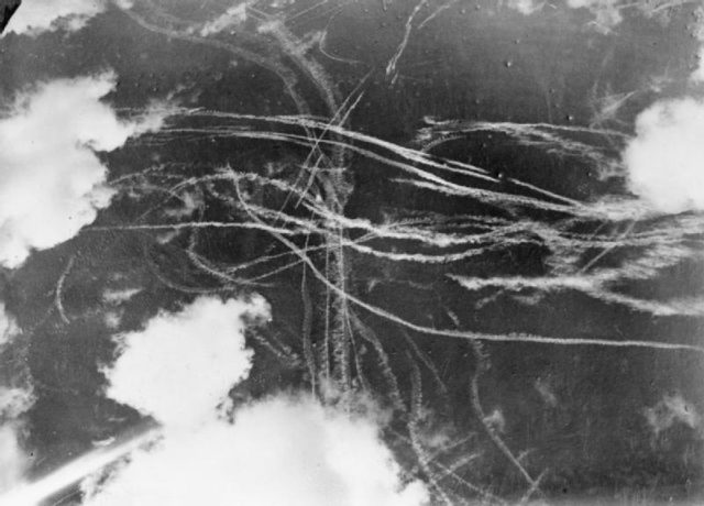 Pattern of condensation trails left by British and German aircraft after a dogfight. By Puttnam (Mr), War Office official photographer - This is photograph H 4219 from the collections of the Imperial War Museums (collection no. 4700-37), Public Domain, https://commons.wikimedia.org/w/index.php?curid=2867178