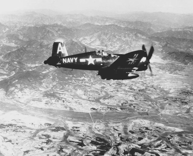 A Vought F4U Corsair over Korea in 1951. The extra fuel tank and rockets were a very similar load out to what Hudner and Brown's flight would have carried on their fateful mission in 1950. Source: wiki/public domain