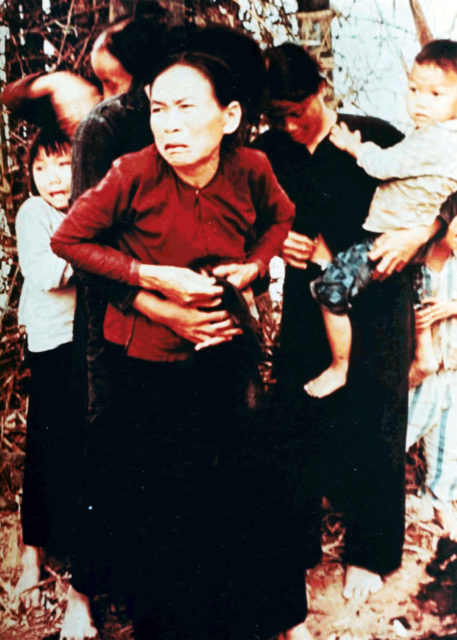 Vietnamese women and children in Mỹ Lai before being killed in the massacre, March 16, 1968. According to court testimony, they were killed seconds after the photo was taken. The woman on the right is adjusting her blouse buttons because of sexual assault that happened before the massacre. Wikipedia / Public Domain