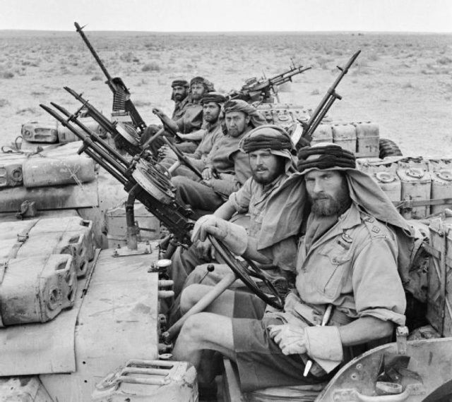 THE SPECIAL AIR SERVICE (SAS) IN NORTH AFRICA DURING THE SECOND WORLD WAR : A close-up of a heavily armed patrol of 'L' Detachment SAS in their Jeeps, just back from a three month patrol. The crews of the jeeps are all wearing 'Arab-style' headdress, as copied from the Long Range Desert Group. Wikimedia Commons / Public Domain