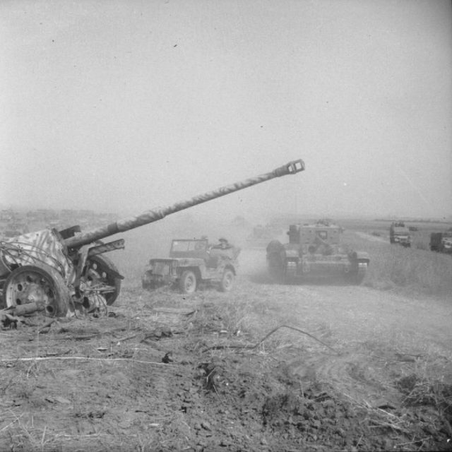A Cromwell tank and jeep pass an abandoned German PAK 43/41 gun during Operation 'Totalise'. By Wilkes (Sgt), No 5 Army Film & Photographic Unit - This is photograph B 8833 from the collections of the Imperial War Museums (collection no. 4700-29), Public Domain, https://commons.wikimedia.org/w/index.php?curid=458287