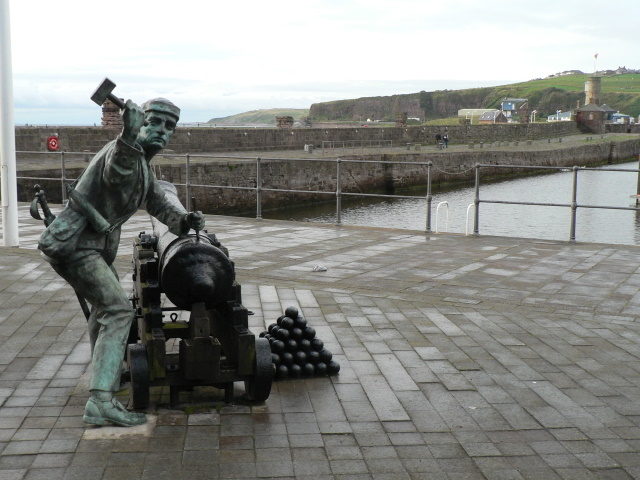 A statue commemorating the destruction of the guns at Whitehaven by John Paul Jones and his men. The sailor is "spiking the gun", or driving a large metal spike into the weapon, rendering it useless. Source: wiki/CC BY-SA 2.0