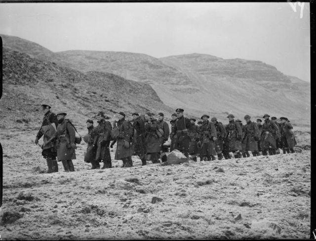 Ratings, loaded with their gear for an attack on enemy positions, on the march to the rendezvous during training at Hvalfjord, Iceland. © IWM (A 7950)