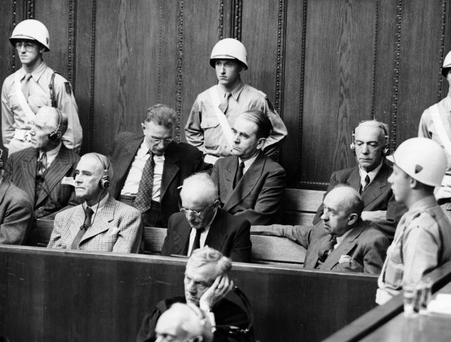 The accused on their bench (front left to right: Wilhelm Frick, Julius Streicher, Walther Funk; back left to right: Franz v. Papen, Arthur Seyß-Inquart, Albert Speer, Konstantin v. Neurath)