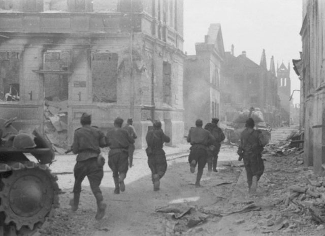 Soviet soldiers advance through the streets of Jelgava; summer 1944.