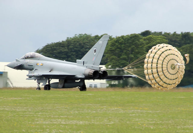 An RAF Typhoon deploying a drag chute as it lands for extra braking Image Source: Arpingstone / Public Domain