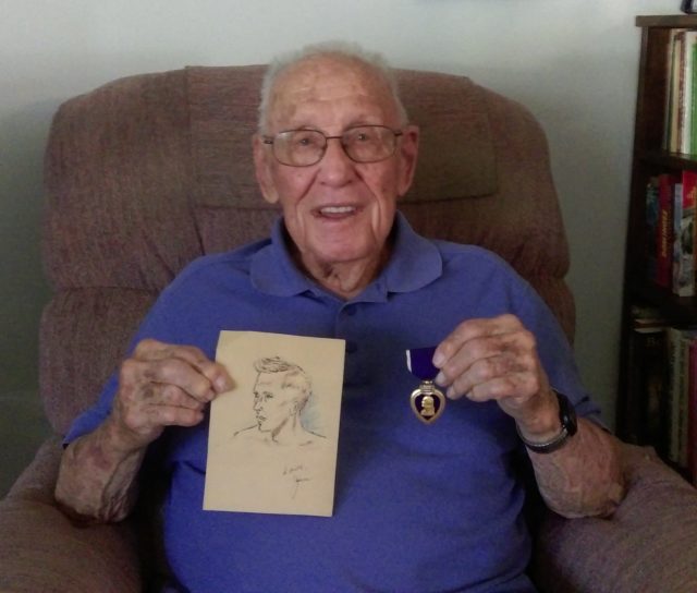WWII veteran James Belshe is pictured in his Eldon, Mo., home holding the Purple Heart medal he received for wounds incurred in 1945 and a picture of him that was drawn by a fellow soldier recovering at a military hospital in New Guinea during the war. Courtesy of Jeremy P. Ämick.