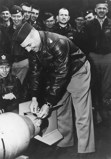 Lieutenant Colonel Doolittle wires a Japanese medal to a bomb, for "return" to its originators.
