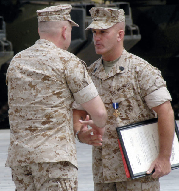 Marine Sergeant Maj. Bradley A. Kasal, right, receives congratulations after his promotion from first sergeant to sergeant major during a ceremony at Marine Corps Base Camp Pendleton, Calif., May 1. The Afton, Iowa, native received the Navy Cross, promoted and reenlisted during the ceremony. (Photo by: Sgt. Luis R. Agostini)