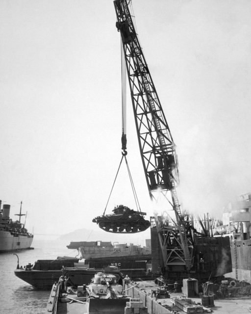 An M4 Sherman tank being loaded into a barge at the port of Oakland, California, prior to shipment to Pusan, 1950.