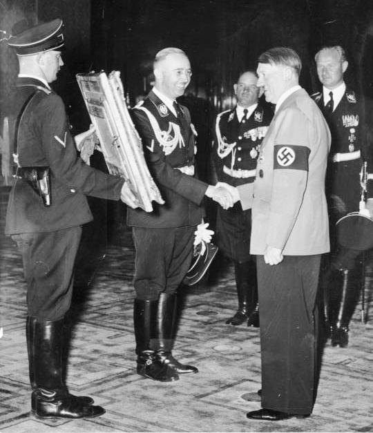 Reichsführer-SS Heinrich Himmler presents Hitler with a gift. Photo Credit.