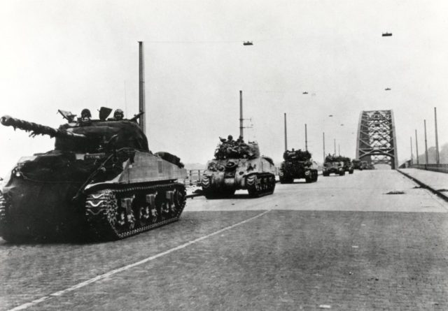 British tanks rolling over the newly captured Nijmegen Bridge. Image Source: Wikimedia Commons/ By Unknown - http://www.spaarnestadphoto.nl (Fotonummer SFA003012896), CC BY-SA 2.0, https://commons.wikimedia.org/w/index.php?curid=11871233