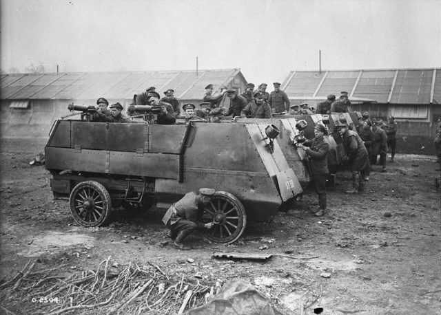 Cleaning armoured cars, Canadian Motor Machine Gun Brigade. Photograph shows six armoured autocars of the First Canadian Motor Machine Gun Brigade, being cleaned. The nearest vehicle is fitted with two Vickers machine guns. Presumably in France. 