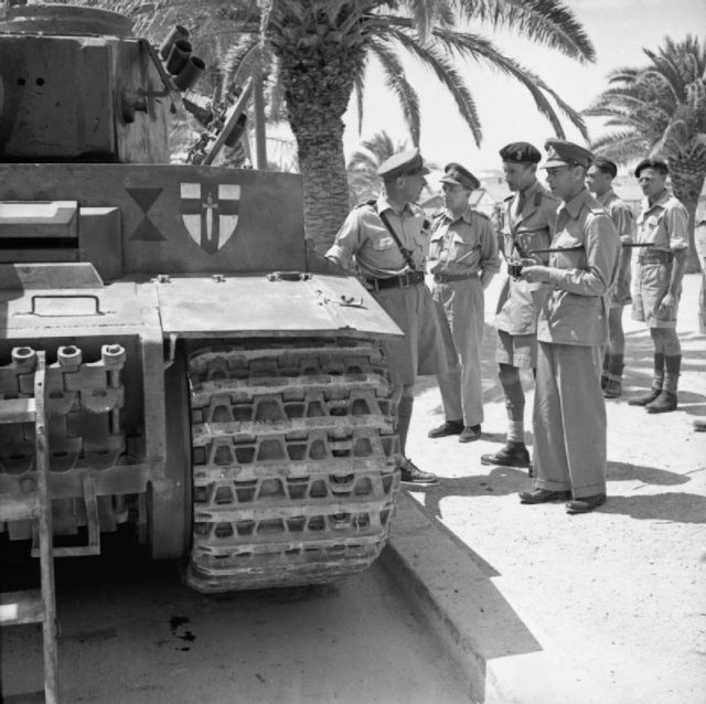 King George VI inspects Tiger 131, Tunis June 1943. The badge of the British First Army has been painted onto the tank.
