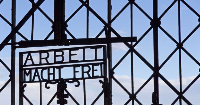 The Arbeit Macht Frei sign in the main gate of Dachau concentration camp, Germany. Photo: GaryBlakeley / CC BY-SA 3.0