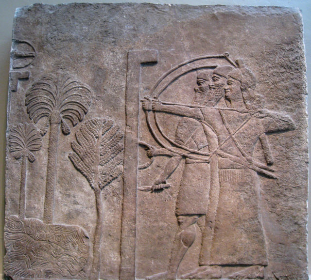 An Assyrian soldier holds a large shield to protect two archers as they take aim. From the Central Palace in Nimrud and now in the British Museum, London. Circa 728 BC.