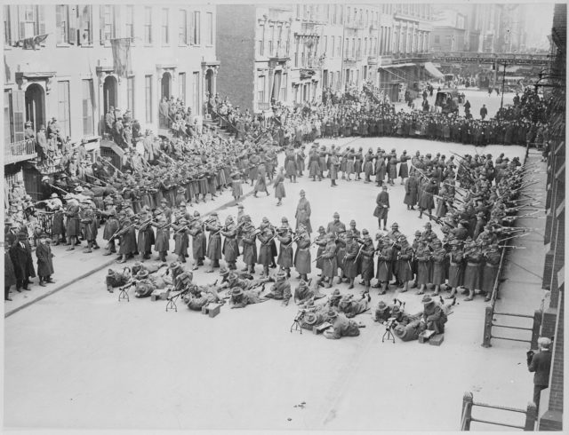 A battalion of the U.S. Army Coast Artillery Corps demonstrating the hollow square formation used in the event of a street riot, 1918.
