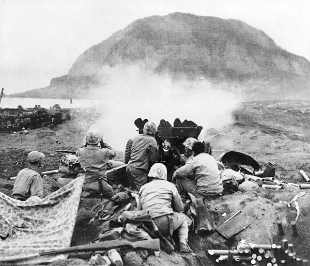 US soldiers pounding Japanese cave positions on Mt. Surabachi on Iwo Jima Photo Credit