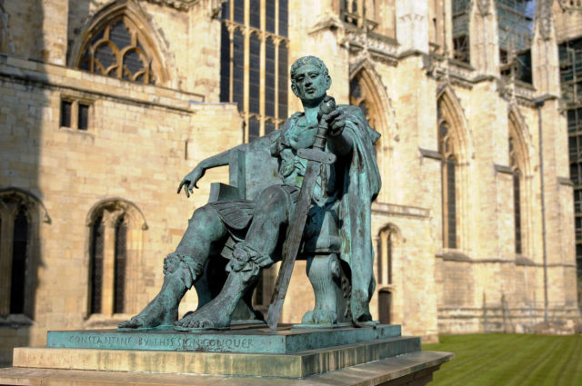 Bronze statue of Constantine the Great outside York Minster, England. The Emperor looks down upon his broken sword, which forms the shape of a cross. The statue was erected by the York Civic Trust and unveiled on 25 July 1998. By Son of Groucho – CC BY 2.0