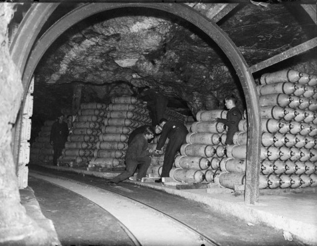 Men stack bombs at an RAF munitions store.