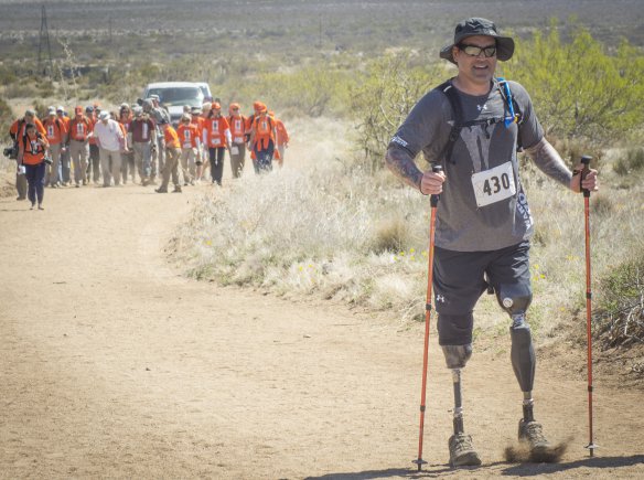 Former Navy Special Operations Master Chief Harold Bologna, of Virginia Beach, Va., walks ahead of retired U.S. Army Col. and Bataan Death March Survivor Ben Skardon and his entourage during the 27th annual Bataan Memorial Death March at White Sands Missile Range, N.M., March 20, 2016. Bologna lost his legs when he stepped on a land mine in Afghanistan in October, 2015 - just five months prior to this. Skardon, 98, is the only Bataan survivor that walks in the march. Both men walked more than eight miles. Photo Credit: Staff Sgt. Ken Scar.