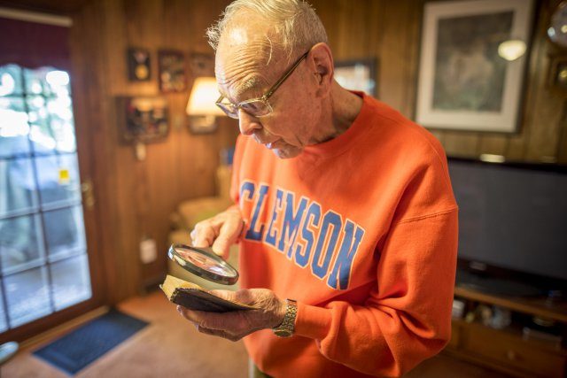 Former U.S. Army 1st Lt. William H. Funchess, 89, reads from a Bible he kept throughout his 34 months as a prisoner of war during the Korean War, Sept. 21, 2016. Funchess was held in the same prison compound as Army Chaplain Father Emil J. Kapaun, who received the Medal of Honor posthumously in 2013 for his acts of courage and compassion as a prisoner of war and is under consideration for Sainthood by the Vatican. Funchess and Kapaun read from this Bible together on many occasions before Kapaun succumbed to starvation and disease. Credit: U.S. Army photo by Staff Sgt. Ken Scar.