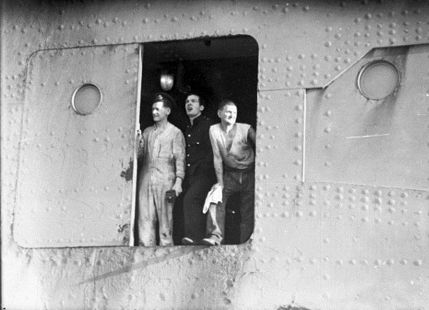 Three unidentified men possibly on board RMS QUEEN MARY near Port Jackson in Sydney, May 1940.