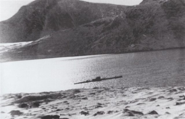 U-537 rides at anchor in Martin Bay (also known as Attinaukjuke Bay) on the Labrador coast of Newfoundland twenty miles south of Cape Chidley on October 23, 1943. One of the U-boat’s crewmen snapped this photograph from the site of the weather station on the Hutton Peninsula.