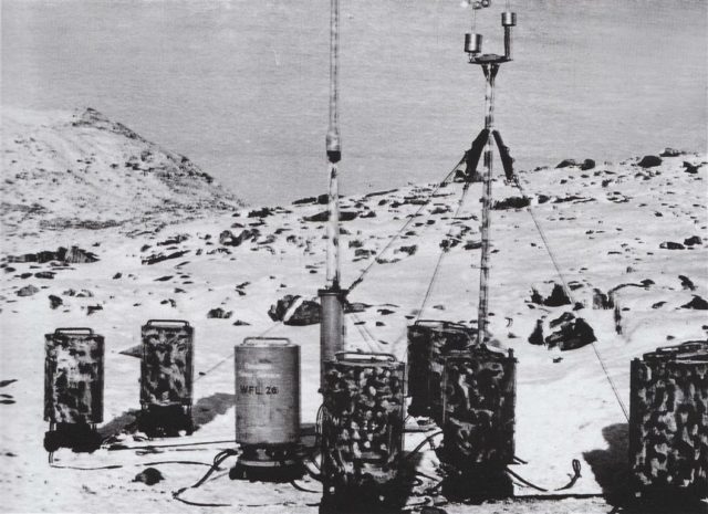 A shot of the automated weather station Wetter-Funkgerät Land-26 (WFL-26) as it appeared on the day of its installation – October 23, 1943. Note that the Germans marked the 10 cylinders with the words “Canadian Weather Service” despite the fact that the Labrador coast of Newfoundland did not become a part of Canada until 1949.