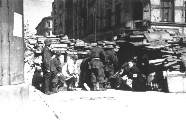 Warsaw Uprising: Battalion “Pięść” defend barricade in Śródmieście district.