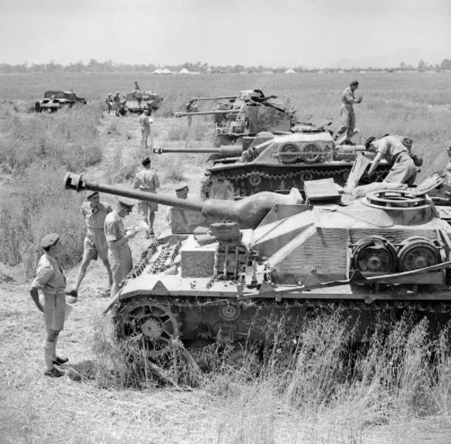 British troops inspect captured German equipment, including a StuG IV and a StuG III; Photo Credit