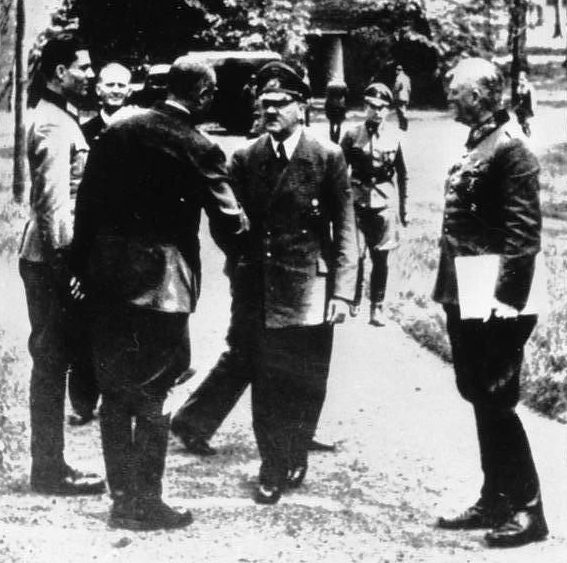 Claus von Stauffenberg (far left) meeting Adolf Hitler at the Wolfsschanze five days before the 20 July plot in 1944. By Bundesarchiv – CC BY-SA 3.0 de