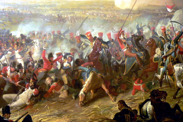 British 10th Hussars of Vivian’s Brigade (red shakos – blue uniforms) attacking mixed French troops, including a square of Guard grenadiers (left, middle distance) in the final stages of the battle.