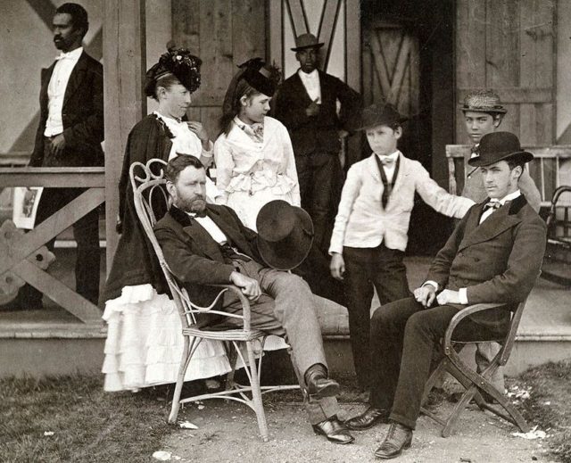 Grant (left, seated) in later life, with his wife (left, standing) and children.