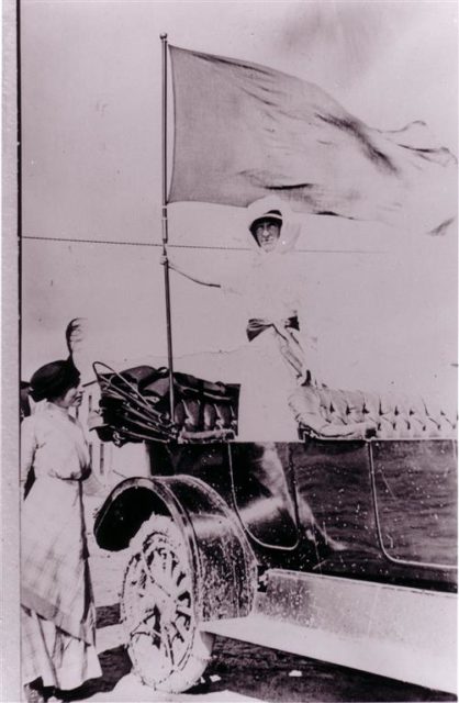 Jeannette Rankin, Chairman Montana Activities, (1912-1914) holding suffrage banner.