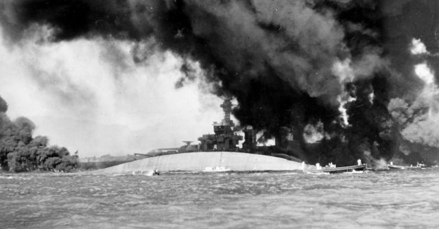 View of the capsized U.S. Navy battleship USS Oklahoma (BB-37) at Pearl Harbor.