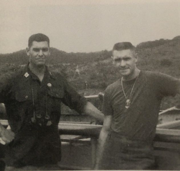 Photo credit: ‘We Were Soldiers Once … and Young,’ by Harold G. Moore and Joseph L. Galloway. John Herren (left) and Bob Edwards (right) were friends training in Fort Benning, fighting in Vietnam and now, 52 years later, remembering other friends and comrades lost in the Battle of Ia Drang. They are pictured together here on the way to Vietnam.
