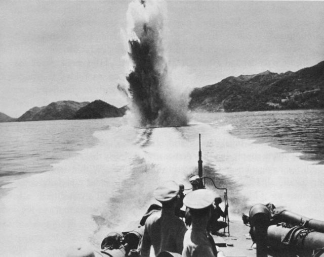 Photo shows the explosion of a Depth Charge, launched from the PT boat at full speed. This was a serious deterrent to keep any pursuing enemy ship at bay. Even a destroyer could be fatally damaged by this warhead with 300 lbs. of TNT if it exploded under its keel.