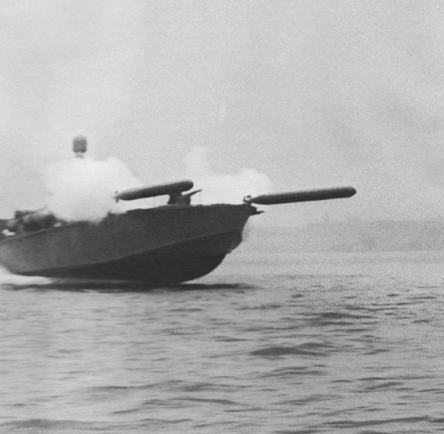 Photo above shows a very fast PT boat launching two torpedoes from its launching tubes. In the reality, things sometimes went awry and the explosive launches as seen in the photo often gave a flash that at night could unveil the position of the PT boat to enemy ships. Note the radar housing, towering just above the smoke, which suggests that this is a photo taken later in the war. That early Radar ( also used in the patrol aircraft as the PBY Catalina and the B-24 Liberator) gave the crews a spy eye in all weather conditions and at night for approaching enemy aircraft and ships. Read more details of the Radar applications in my next Dakota Hunter Blog Vol.2.