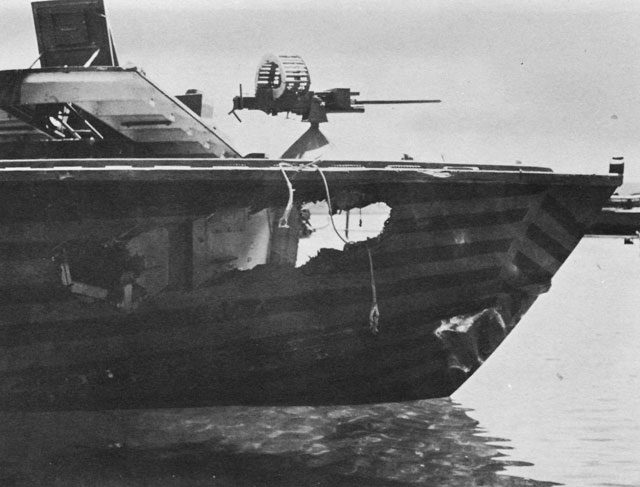 Photo depicts severe damage caused by a “dud” torpedo that seemed to have ignited prematurely just after its launch. The explosion blew part of the wooden panels of the hull in pieces on both sides of the bow. The photo shows the vulnerability of the light weight ships, with no armored plating at all.