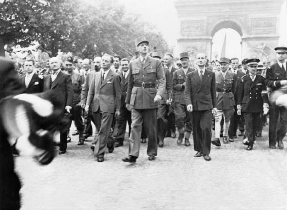 General de Gaulle and his entourage stroll down the Champs Élysées following the liberation of Paris in August 1944.