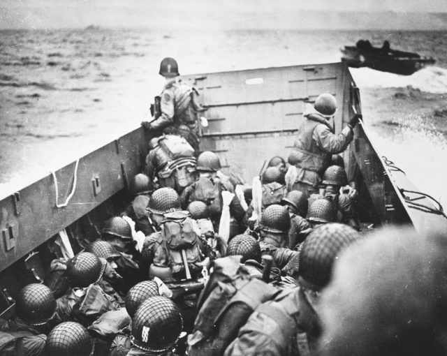 U.S. troops crouch inside an LCVP landing craft, just before landing on “Omaha” Beach on D-Day.