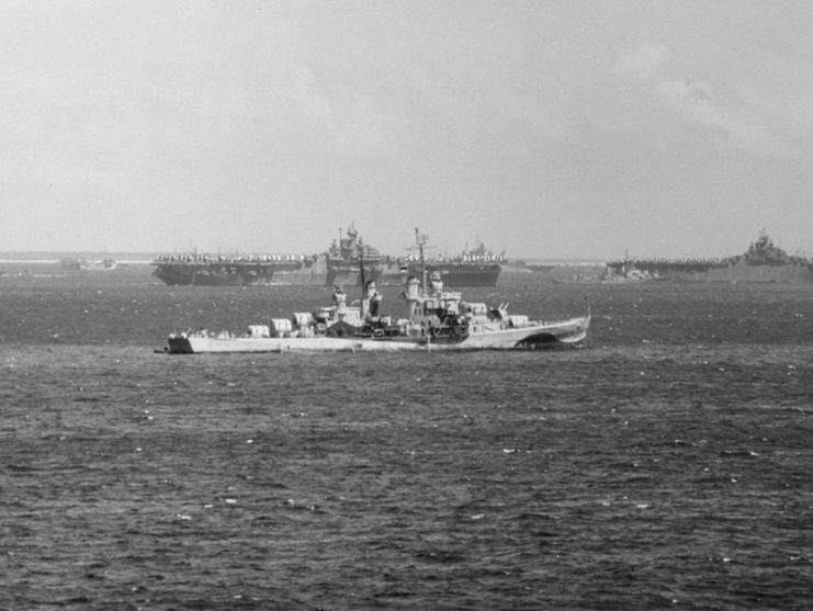 The U.S. Navy Atlanta-class cruiser USS Flint (CL-97), probably at Ulithi Atoll, circa late March 1945, as the U.S. Fifth Fleet was departing for the Okinawa operation. Flint´s camouflage is Measure 33, Design 22d. Note the two Essex-class carriers in the background, the left one probably being USS Bon Homme Richard (CV-31). USS Tennessee (BB-43) is visible in the background (her sister ship California was under repair at Puget Sound at that time).