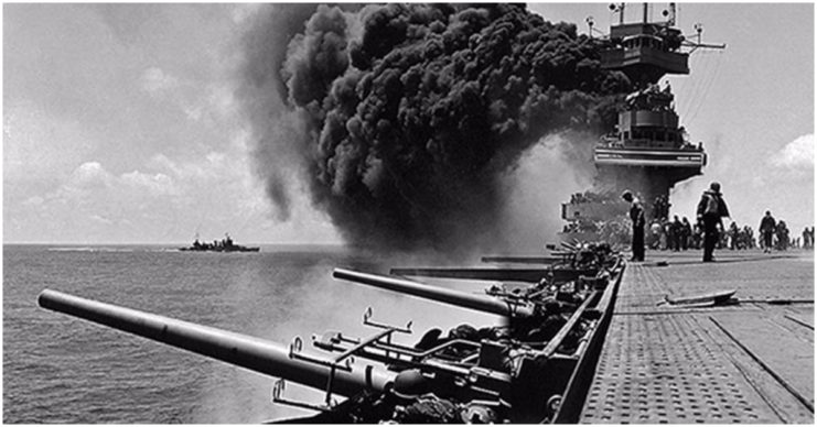 Smoke billows from the carrier USS Yorktown before in sank during the Battle of Midway in June 1942.