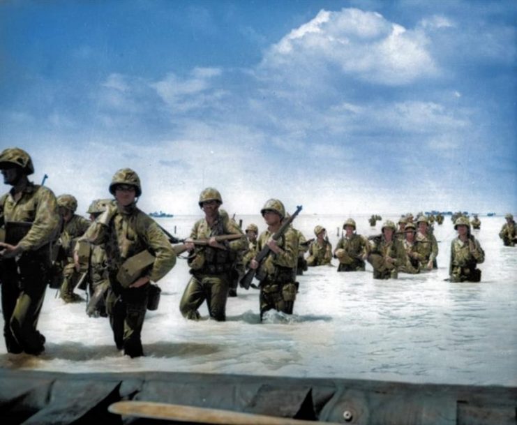 US Marines wading through surf from landing boats and barges to the beach during the invasion of Tarawa. Royston Leonard / mediadrumworld.com